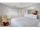 Bright bedroom offers a bed, closet, dresser, and a comfortable reading chair at 4420 Tecumseh Trl # 38, Sarasota, FL 34233