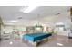 Spacious clubhouse featuring seating, tables, and a billiard table, perfect for social gatherings and recreation at 4420 Tecumseh Trl # 38, Sarasota, FL 34233