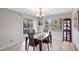 Traditional dining room with chandelier, wood table and chairs, and view to the screened in patio at 4420 Tecumseh Trl # 38, Sarasota, FL 34233