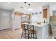 Bright kitchen featuring a breakfast bar, white appliances, and wooden cabinets at 4420 Tecumseh Trl # 38, Sarasota, FL 34233