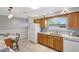 Functional kitchen featuring a window over the sink, stainless steel appliances, and wooden cabinets at 4420 Tecumseh Trl # 38, Sarasota, FL 34233