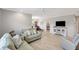Bright living room features neutral colors, ceiling fan, light wood floors, and comfortable couches at 4420 Tecumseh Trl # 38, Sarasota, FL 34233