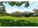 Expansive backyard with lush lawn, mature trees, and landscaping, offering a peaceful and private outdoor retreat at 4444 Highland Oaks Cir, Sarasota, FL 34235