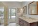 Bathroom with double sink vanity and access to the lanai at 4444 Highland Oaks Cir, Sarasota, FL 34235