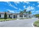 Charming community clubhouse featuring elegant design, landscaped grounds, and accessible parking for residents and guests at 4444 Highland Oaks Cir, Sarasota, FL 34235
