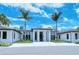 A modern clubhouse with palm trees enhances the community aesthetic and provides a social and recreational hub at 4444 Highland Oaks Cir, Sarasota, FL 34235