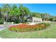Welcoming entrance to The Meadows community with lush landscaping and a stone sign at 4444 Highland Oaks Cir, Sarasota, FL 34235