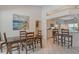 Inviting dining area with a view into the kitchen featuring a breakfast bar and bright natural light at 4444 Highland Oaks Cir, Sarasota, FL 34235