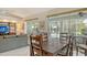 Open floor plan with seamless integration between living, dining, and outdoor screened pool area at 4444 Highland Oaks Cir, Sarasota, FL 34235