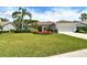 Charming one-story home featuring lush landscaping and a two-car garage at 4444 Highland Oaks Cir, Sarasota, FL 34235