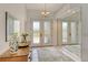 Elegant foyer with tiled floors, a mirrored wall, and a chandelier at 4444 Highland Oaks Cir, Sarasota, FL 34235