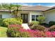 Inviting front entrance with lush landscaping and a brick walkway leading to the front door at 4444 Highland Oaks Cir, Sarasota, FL 34235