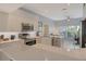 Modern kitchen with stainless steel appliances, quartz countertops, and ample cabinet space, perfect for cooking and entertaining at 4444 Highland Oaks Cir, Sarasota, FL 34235