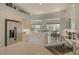 Well-equipped kitchen featuring stainless steel appliances, white cabinets, and a view to the indoor and outdoor dining areas at 4444 Highland Oaks Cir, Sarasota, FL 34235