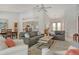 Open-concept living room with comfortable seating, neutral colors, and views into the kitchen and dining area at 4444 Highland Oaks Cir, Sarasota, FL 34235