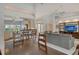 Open-concept living room with high ceilings, tiled floors, and seamless flow to the dining area and kitchen at 4444 Highland Oaks Cir, Sarasota, FL 34235