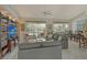 Spacious living room with large windows overlooking the pool and patio area at 4444 Highland Oaks Cir, Sarasota, FL 34235