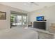 Relaxing bedroom featuring tiled floors, a sliding glass door to the pool area, and a serene ambiance at 4444 Highland Oaks Cir, Sarasota, FL 34235