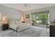 Serene bedroom with tiled floor, large windows leading to a screened patio, and an airy atmosphere at 4444 Highland Oaks Cir, Sarasota, FL 34235