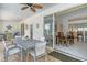Relaxing outdoor patio featuring brick flooring, ceiling fans, and a seamless transition to indoor dining at 4444 Highland Oaks Cir, Sarasota, FL 34235
