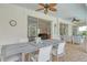 Inviting outdoor patio with brick flooring, ceiling fans, comfortable seating, and dining table, perfect for entertaining at 4444 Highland Oaks Cir, Sarasota, FL 34235