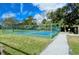 Pickleball court with new nets, fenced, near a shaded area for convenient outdoor recreation and leisure at 4444 Highland Oaks Cir, Sarasota, FL 34235