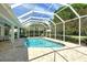 A lovely enclosed pool with a screened-in lanai for outdoor enjoyment and relaxation by the clear water at 4444 Highland Oaks Cir, Sarasota, FL 34235