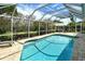 Refreshing screened-in pool offers a private oasis with plenty of room for swimming and relaxing in the sun at 4444 Highland Oaks Cir, Sarasota, FL 34235