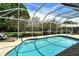 Screened in pool with deck chairs at 4444 Highland Oaks Cir, Sarasota, FL 34235