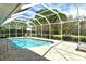 Beautiful screened-in pool with clear blue water and patio space for lounging and enjoying the outdoors at 4444 Highland Oaks Cir, Sarasota, FL 34235