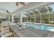 Perfect for entertaining, this home features a spacious screened patio next to the pool and lush landscaping at 4444 Highland Oaks Cir, Sarasota, FL 34235