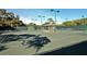 Tennis court with lighting, nets, and a covered seating area encourages an active lifestyle for community residents at 4444 Highland Oaks Cir, Sarasota, FL 34235