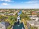 Aerial shot of the community showcasing waterfront homes along canals and boat docks under a blue sky at 4527 Barracuda Dr, Bradenton, FL 34208