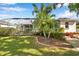 Landscaped backyard with green grass, pool, patio, and view of other homes at 4527 Barracuda Dr, Bradenton, FL 34208