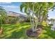 Expansive lawn in the backyard with lush landscaping and screened lanai, perfect for outdoor entertaining at 4527 Barracuda Dr, Bradenton, FL 34208