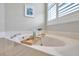 Bright bathroom features a soaking tub, marble countertop, and shutters on the windows at 4527 Barracuda Dr, Bradenton, FL 34208