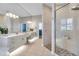 Spacious bathroom featuring double vanities, a large mirror, and a glass-enclosed shower at 4527 Barracuda Dr, Bradenton, FL 34208