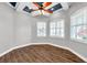 Bright bedroom featuring wood-look flooring, plantation shutters, and gray walls at 4527 Barracuda Dr, Bradenton, FL 34208