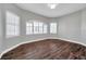 Bright bedroom with wood-look flooring, two windows with plantation shutters, and gray walls at 4527 Barracuda Dr, Bradenton, FL 34208