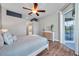 Bedroom showcasing wood flooring, dresser, and a private sliding door leading to the outdoor patio/pool at 4527 Barracuda Dr, Bradenton, FL 34208