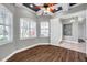 Bedroom with tray ceiling, shuttered windows, and wood-look flooring at 4527 Barracuda Dr, Bradenton, FL 34208