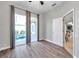 Neutral bedroom with vinyl floors, slider to pool, and view to the kitchen at 4527 Barracuda Dr, Bradenton, FL 34208