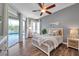 Bright bedroom with pool access, featuring a ceiling fan, neutral tones, and ample natural light at 4527 Barracuda Dr, Bradenton, FL 34208