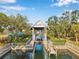 Covered boat lift with dock and manicured landscaping, offering direct access to the canal at 4527 Barracuda Dr, Bradenton, FL 34208