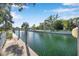 Scenic water view of the canal surrounded by mature tropical trees at 4527 Barracuda Dr, Bradenton, FL 34208
