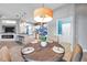 Dining area with a round marble table, seating for four, and pendant light fixture at 4527 Barracuda Dr, Bradenton, FL 34208