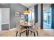 A cozy dining area with a round table set for four, lit by a decorative pendant lamp at 4527 Barracuda Dr, Bradenton, FL 34208