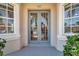 Beautiful double front doors with glass panels and exterior view through windows at 4527 Barracuda Dr, Bradenton, FL 34208