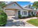 Inviting home featuring well-maintained landscaping and a convenient carport with an attached garage at 4527 Barracuda Dr, Bradenton, FL 34208