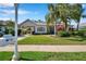 Charming single-story home with lush landscaping, portico, and well-manicured lawn at 4527 Barracuda Dr, Bradenton, FL 34208
